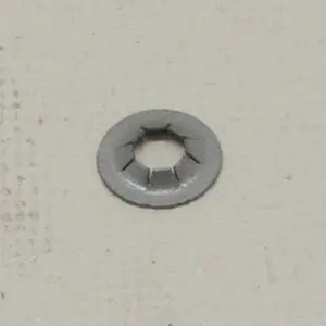 Metal washer on a textured surface.