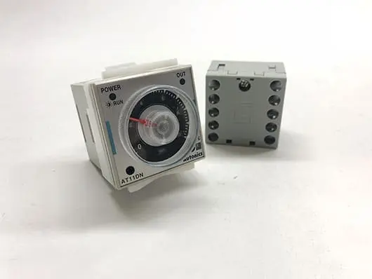 Timer switch and socket on white background.