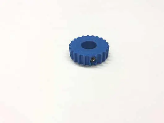 Blue plastic gear on white background.