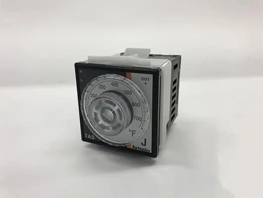 Analog temperature controller on white background.
