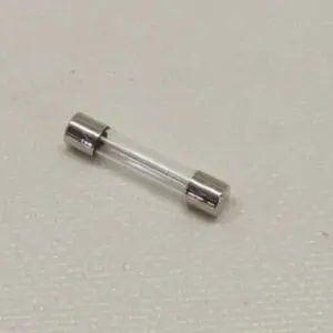 Glass tube fuse on textured surface.