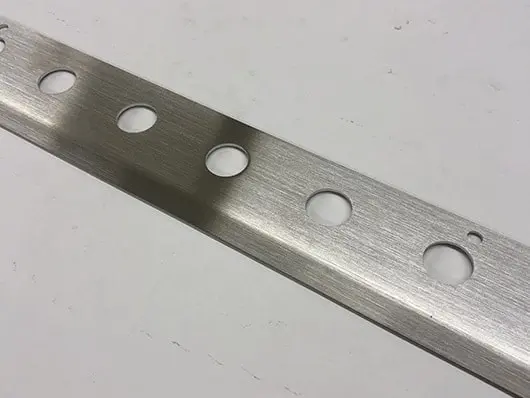 Brushed metal strip with holes.