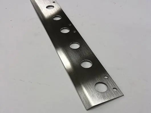 Brushed metal strip with holes.
