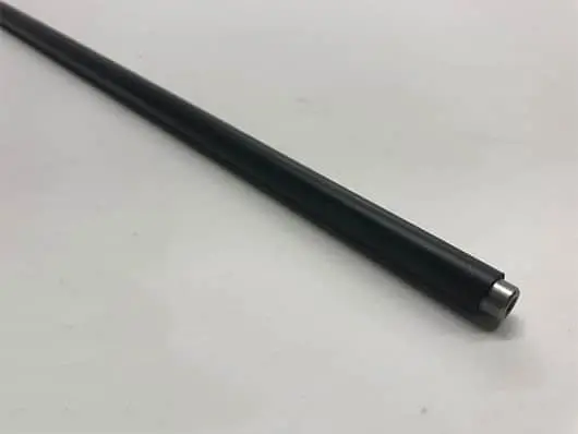 Black rod on a white surface.