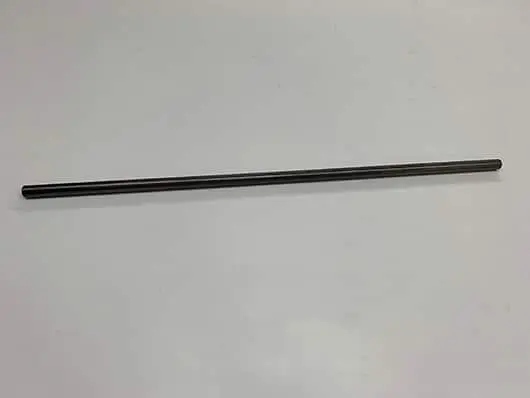Metal rod on a white surface.