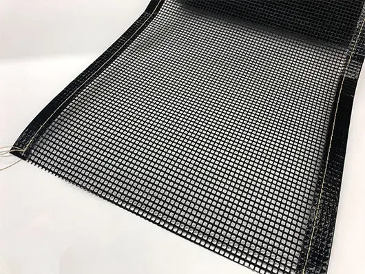 Black mesh sheet rolled out on surface.