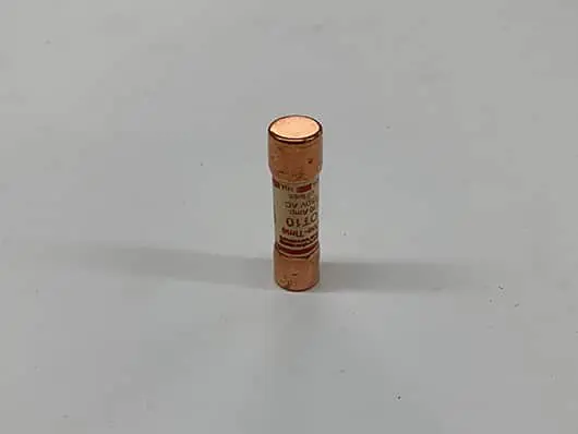 Small cylindrical copper electrical connector on table.