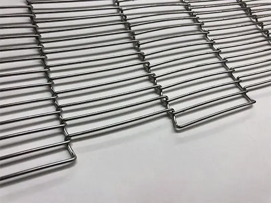 Interwoven metal wire mesh on surface.