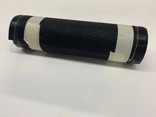 Rolled black mat with white tape.
