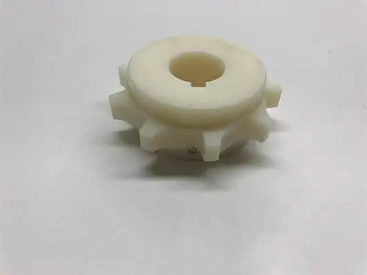 White plastic gear on white background.