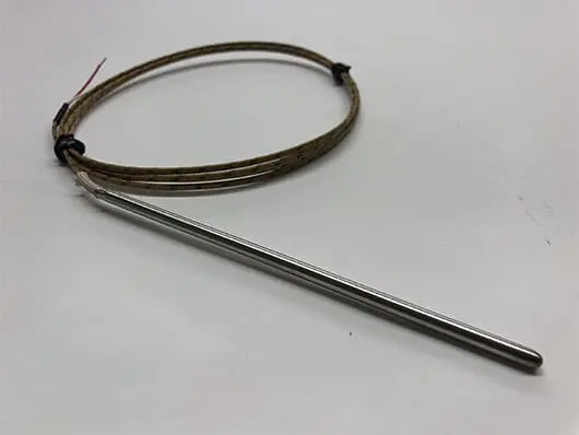 Metal probe sensor with attached cable coil.