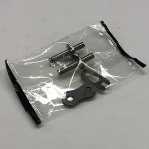 Here's a short alt tag for the image: Motorcycle chain repair kit parts.