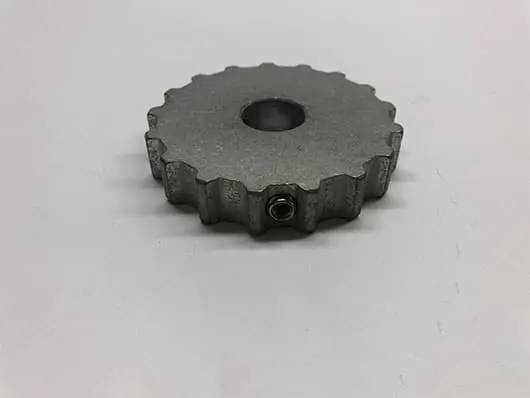 Metal gear with central hole on surface.