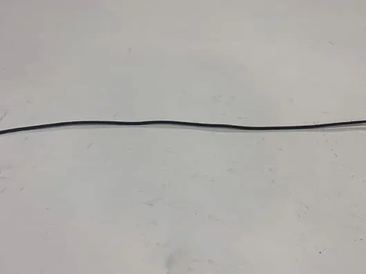 Black cable on white surface background.
