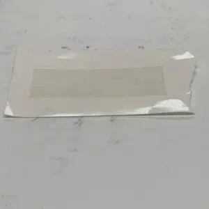 Torn paper with adhesive rectangle.