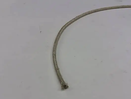 Bent metal cable on a white background.