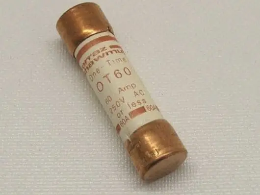 Electrical fuse with copper ends on surface.