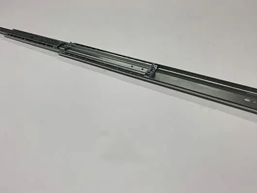 Metal drawer slide on white surface.