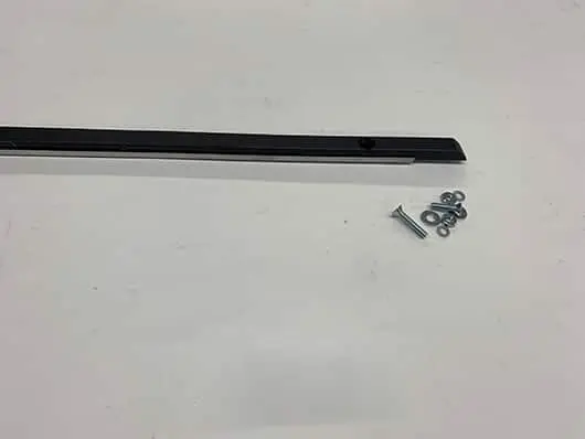 Metal strip with screws on white background.