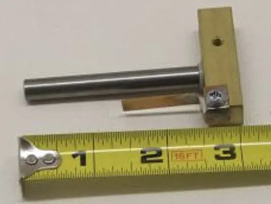 Metal rod with ruler for scale.