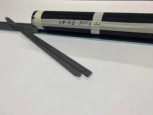 Black mesh roll and metal strips.