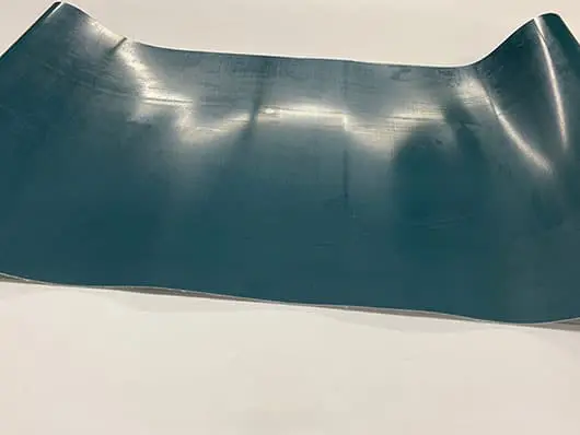 Curved blue sheet on white background.