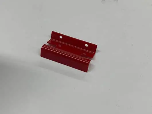 Red metal brackets with holes.