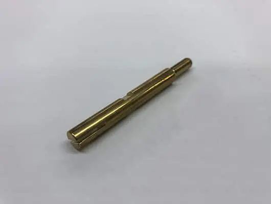Gold metal rod with notches.