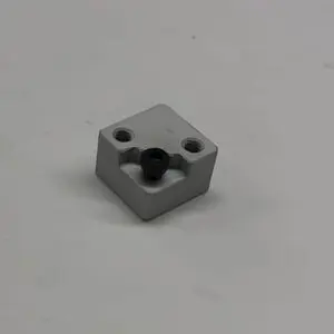 Here's an 8-word alt tag for the image: Gray metal part with a black connector.