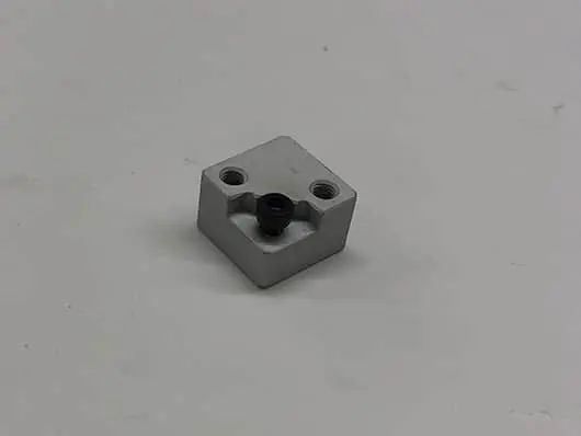 Here's an 8-word alt tag for the image: Gray metal part with a black connector.