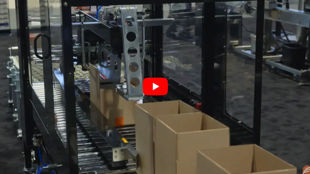 Machine packing boxes on an assembly line.