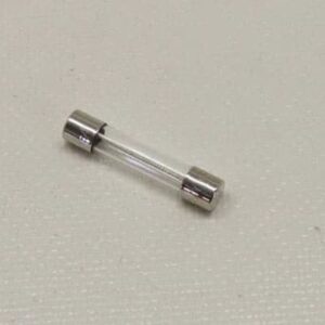 Glass tube fuse on textured surface.