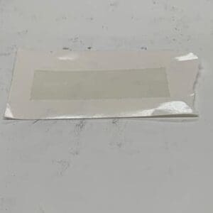 Torn paper with adhesive rectangle.