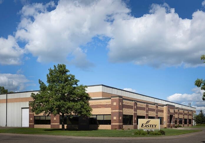 Industrial building with cloudy sky backdrop.