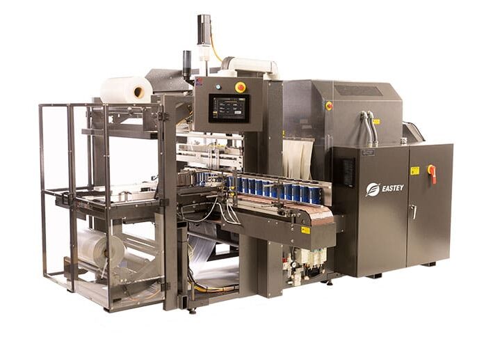 Automated industrial packaging machine with conveyor.