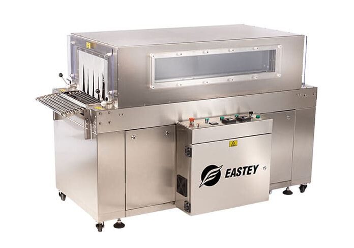 Industrial shrink wrap machine with conveyor belt.